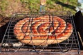 Pork wurst grilled on a coals. Sausages barbecue. Royalty Free Stock Photo