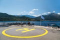 Poros, Cephalonia island, Greece - July, 17 2019: Yellow sign of helipad for helicopters at the ship and passengers