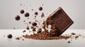 Porous chocolate is broken and flies on a white background. Isolated