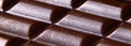 Porous dark Chocolate bar closeup banner. Porous chocolate macro view. Copy space. Vertical orientation