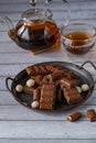milk chocolate on a metal tray against the background of tea in a glass teapot and a mug Royalty Free Stock Photo