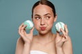 Porrait of a young white woman holding two bath bombs
