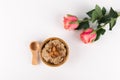 Composition Porridge, Cinnamon, Almonds in a wooden bowl and wooden spoon. ans Two Pink Roses isolated on white background, Royalty Free Stock Photo
