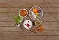 Porridge with fruit bun and coffee on wooden background