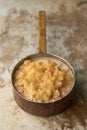 Porridge with Mashed Fruit and Cinammon Powder in Copper Saucepan