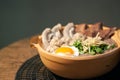 Porridge rice or Congee with egg, pork entrails and ginger slide in a clay pot