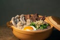 Porridge rice or Congee with egg, pork entrails and ginger slide in a clay pot