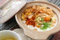 Porridge served on hot claypot topped with chicken, sweet corn, skipjack tuna, tofu, green onions, crackers, dumplings and broth.