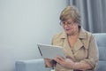 Porrtait of senior woman using electronic tablet at home Royalty Free Stock Photo