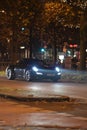 Porsche with a headlight beam on Lueg Allee in Duesseldorf, Germany