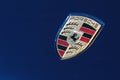 Porsche logo on blue sport car