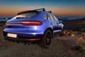 Porsche Macan on top of the mountain at sunrise