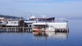Port Angeles, WASHINGTON USA - October 2014: pier with a fishing boat and huge tank ship