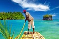 Beautiful caribbean secluded lagoon, jamaican bamboo raft man, rocks, islands , blue sky Royalty Free Stock Photo