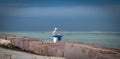 PORT ARANSAS, TX - 7 FEB 2023: Fisherman on pail at the South Jetty