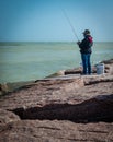 PORT ARANSAS, TX - 7 FEB 2023: Woman fishing at the South Jetty
