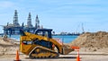PORT ARANSAS, TX - 29 FEB 2020: Yellow CAT front loader moves load of dirt
