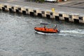 A Port Authority employee in a small boat checking the dock area. Royalty Free Stock Photo