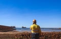 Port authority standing on the harbour having communication regarding safety concerns