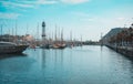 Barcelona marina port with teleferic tower and boats, teal and orange view. Royalty Free Stock Photo