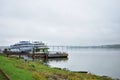 Port berth on the river cruise ships embankment, bridge automobile, fog over Royalty Free Stock Photo