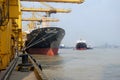 Port cargo crane and container terminal for loading bulk cargo of iron ore by ship cranes and grabs.Container Cargo freight ship Royalty Free Stock Photo