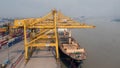 Port cargo crane and container terminal for loading bulk cargo of iron ore by ship cranes and grabs.Container Cargo freight ship Royalty Free Stock Photo