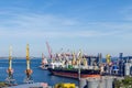 Port cargo crane loads a container onto a cargo ship in a seaport