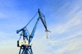 Port crane against a blue sky with a light cloud cover Royalty Free Stock Photo