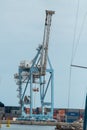 Port crane and cargo containers at a marine terminal. Cargo transportation Royalty Free Stock Photo