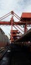 Port crane unloading coal from vessel Royalty Free Stock Photo