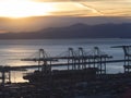 Port cranes cargo ship and container above view at sunset