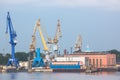 Port cranes with old warehose. Port of St.Petersburg Royalty Free Stock Photo