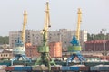 Port cranes with old warehose. Royalty Free Stock Photo