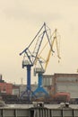 Port cranes on the river bank Royalty Free Stock Photo