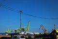 In the port cranes and tractors awaiting loading Royalty Free Stock Photo