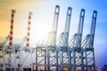 Port cranes working in sea port, Crane of freight dock, Working crane bridge in shipyard at twilight Royalty Free Stock Photo