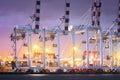 Port cranes working in sea port, Crane of freight dock, Working crane bridge in shipyard at twilight Royalty Free Stock Photo
