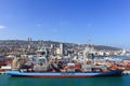 Port dock with container ship and Various brands and colors of shipping containers stacked in a holding platform Royalty Free Stock Photo