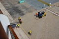 Port Dock workers and cruise ship crew working hard setting up a ramp to transport passengers off the ship