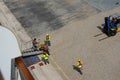 Port Dock workers and cruise ship crew working hard setting up a ramp to transport passengers off the ship