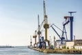 Port facility with cranes and shipyard in the port of Rostock Royalty Free Stock Photo
