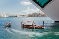 Port with giant cruise ships and small touristic boats between islands with historical districts