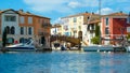 View over water canal on old bridge in mediterranean harbor against blue summer sky