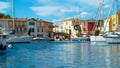 View over water canal on old bridge in mediterranean harbor against blue summer sky