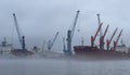 Port of Hamburg on a foggy day- HAMBURG, GERMANY - DECEMBER 17, 2022