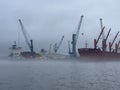 Port of Hamburg on a foggy day- HAMBURG, GERMANY - DECEMBER 17, 2022