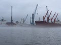 Port of Hamburg on a foggy day- HAMBURG, GERMANY - DECEMBER 17, 2022