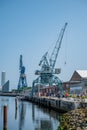 Port Harbor of Aarhus Denmark, wide angle shot during clear sky, cranes, tourists walking at the promenade, vertical shot Royalty Free Stock Photo