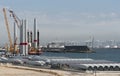 Wind turbine ship loading in the Port of Leaver, France. Turbine components on the quay. Royalty Free Stock Photo